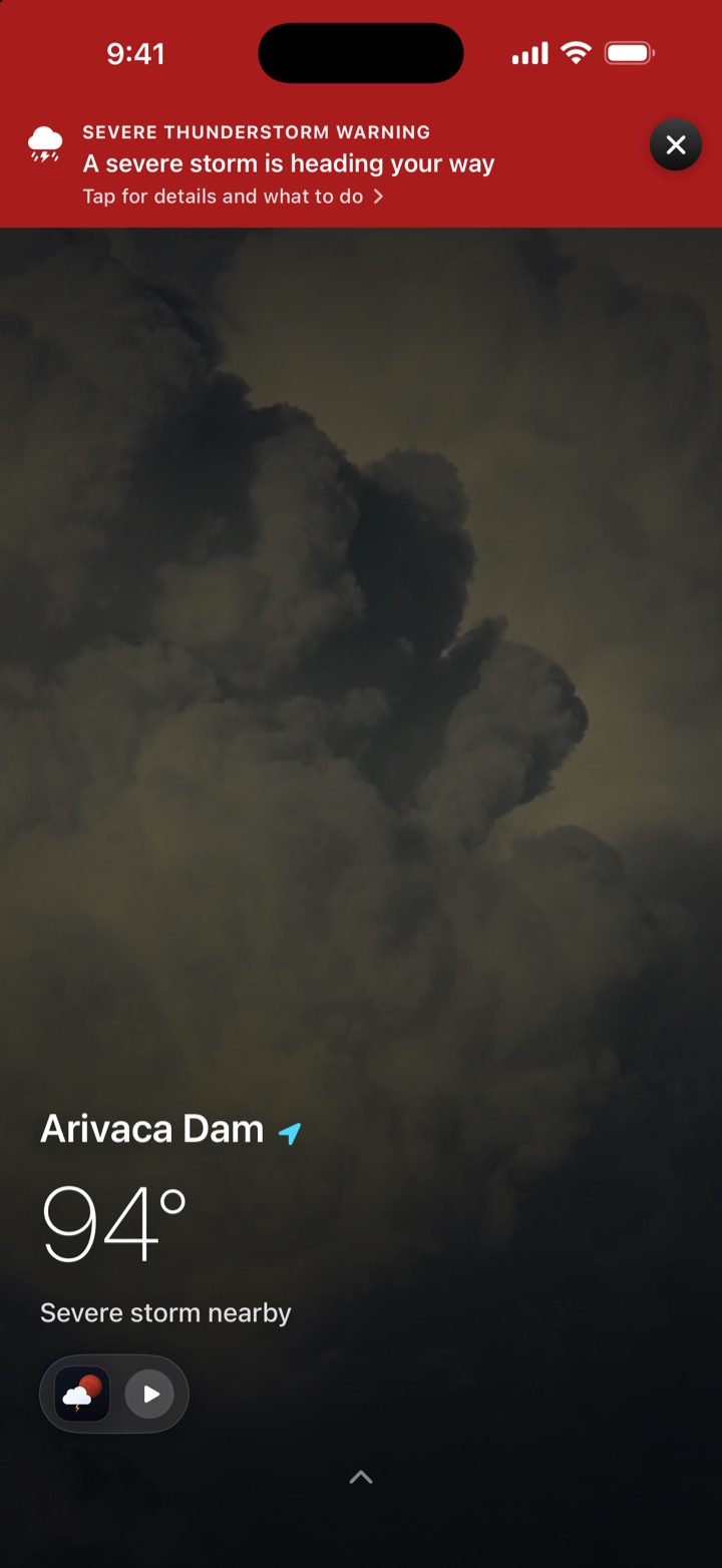 The home screen turned red under a severe thunderstorm warning with the alert banner on top.